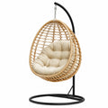 Sedia a dondolo sospesa in rattan e metallo con cuscino beige